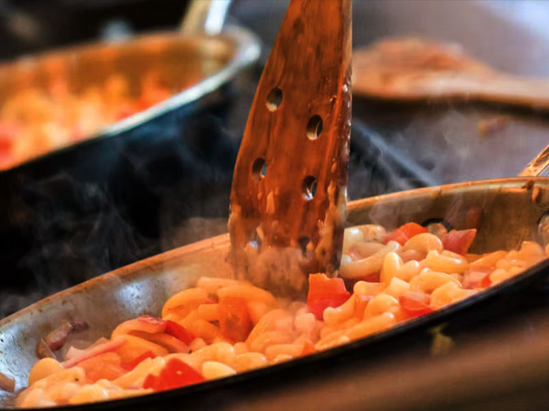 Food photography of a pan over a stove top with a delicious looking sauce